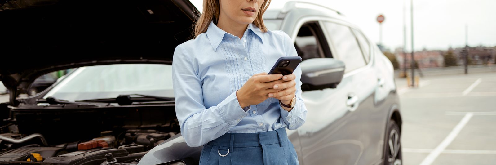 Woman with vehicle engine problem or accident and emergency help from a professional mechanic